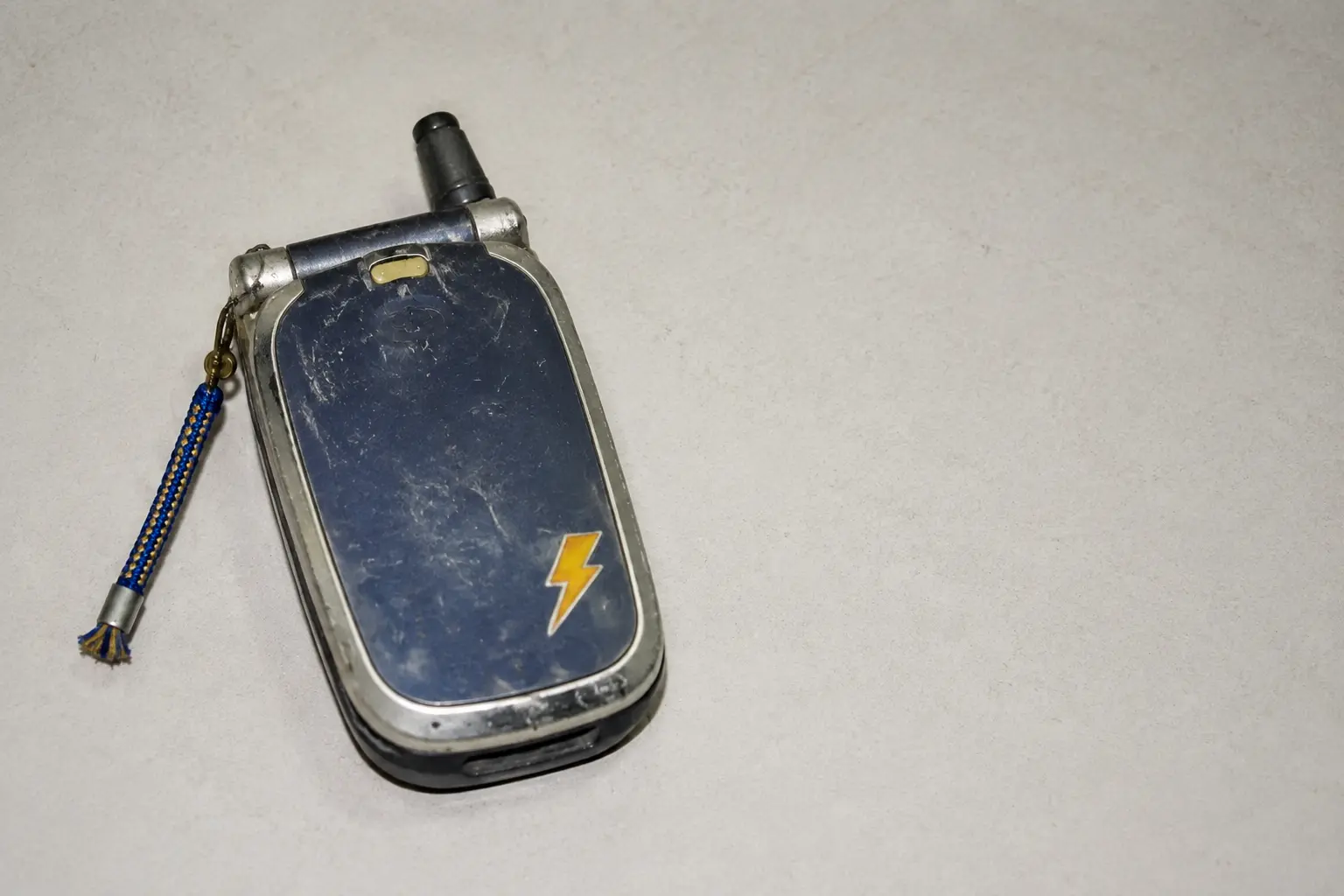 Clacky closed, showing a scratched shell and yellow lightning sticker.